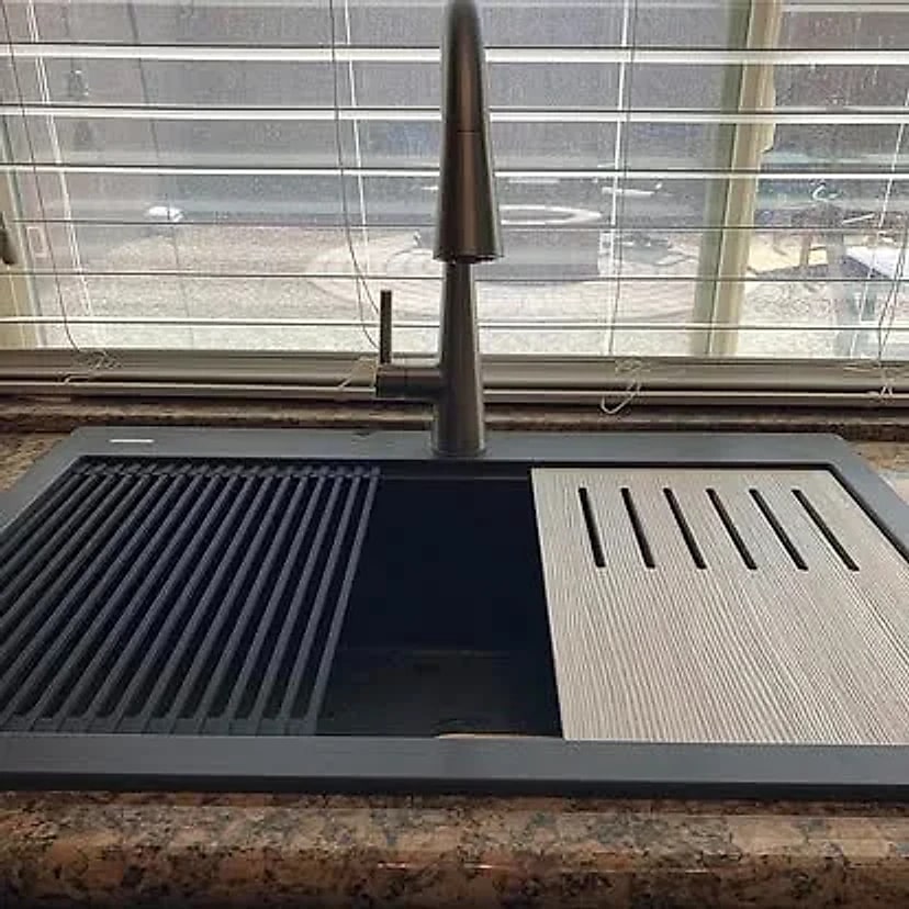 Dark workstation kitchen sink and high-arc faucet after installation