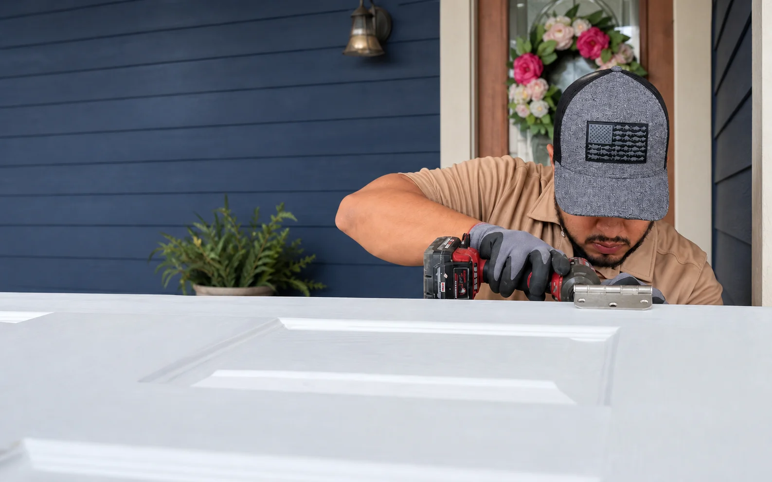 Handyman fitting hardware to a residential entry door